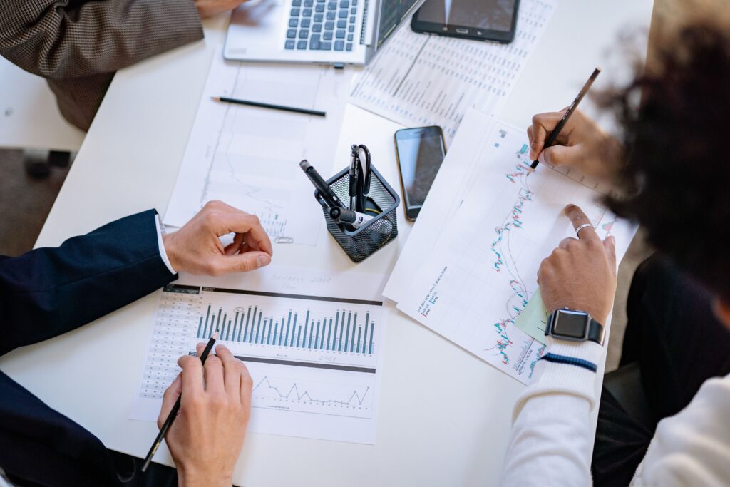 Home Business team analyzing financial charts and graphs during a collaborative meeting.